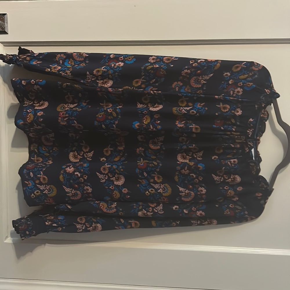 100% silk navy floral Boden blouse with ruffle detail and smocked cuffs.